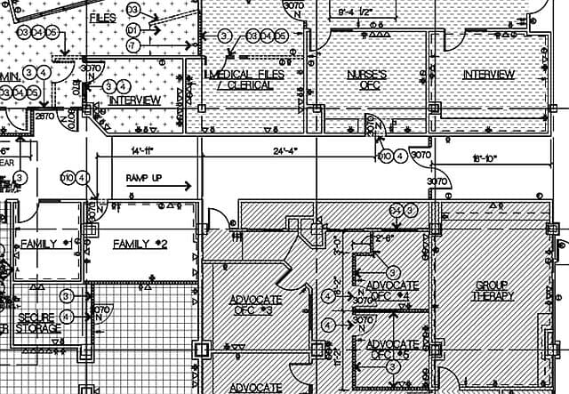 A working floor-plan drawing of the Dawson Place Child Advocacy Center — fine black line on white, with dimensioned rooms labelled Interview, Nurse’s Office, Group Therapy, Advocate Offices and Secure Storage, door-swing arcs and numbered annotation bubbles.